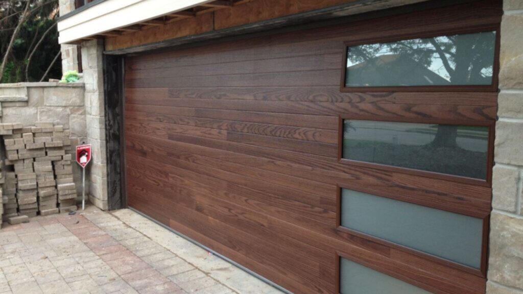 A Modern Style Garage Door with Long Slatted Windows and Dark Brown Wood Color.