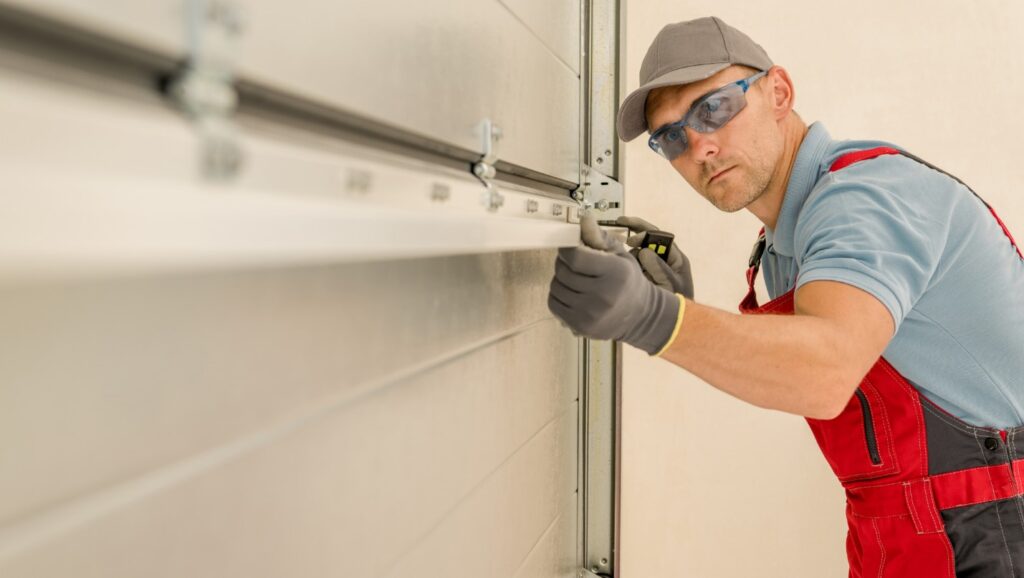 A Technician Wearing Safety Glasses and Gloves Measures a Garage Door.