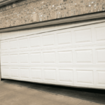 A garage door that is slightly askew preventing it from closing