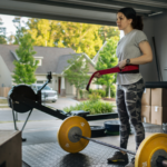 A Woman in Her Garage Home Gym Puts On A Weightlifting Belt
