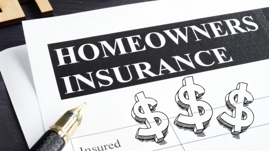 A paper that says homeowners insurance next to a pen and graphic dollar signs.
