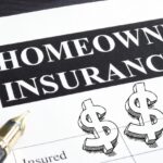 A paper that says homeowners insurance next to a pen and graphic dollar signs.