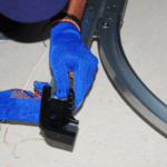 A garage door technician repairs the track on a new garage door.