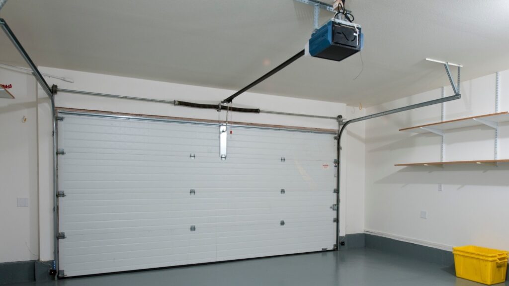 A clean garage interior with a clear garage door opener in view.