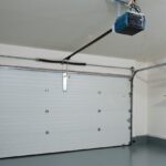 A clean garage interior with a clear garage door opener in view.
