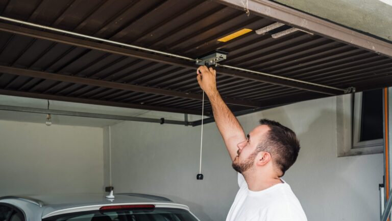A man opens his garage door to inspect it for subtle damage.